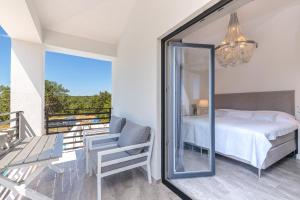 a bedroom with a bed and a balcony with a mirror at Valhalla in Barat +72 photos
