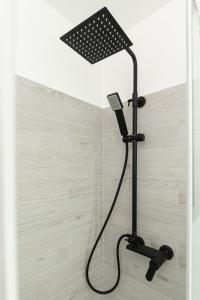 a shower with a shower head in a bathroom at Sea Loft Quinto - A due passi dal mare in Genoa