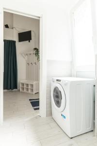 a white laundry room with a washing machine at Sea Loft Quinto - A due passi dal mare in Genoa