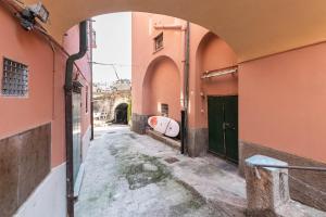 an alley in a city with pink buildings at Sea Loft Quinto - A due passi dal mare in Genoa