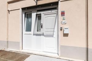 a white door on the side of a building at Sea Loft Quinto - A due passi dal mare in Genoa