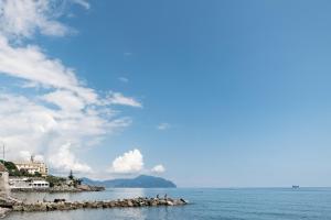 a group of people on a small island in the water at Sea Loft Quinto - A due passi dal mare in Genoa