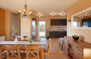 a kitchen and dining room with a table and chairs at White Pearl in Čabrunići