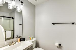 a white bathroom with a sink and a mirror at Palm Coast Vacation Rental about 8 Mi to Flagler Beach in Flagler Beach +27 photos