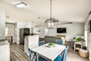 a kitchen and living room with a white table and chairs at Palm Coast Vacation Rental about 8 Mi to Flagler Beach in Flagler Beach