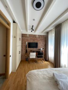 a bedroom with a bed and a tv on a brick wall at Amsterdam-bnb in Amsterdam
