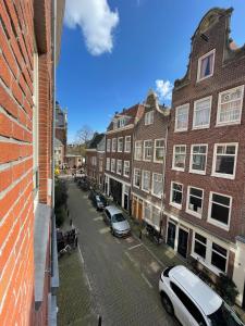 a view of a street with parked cars and buildings at Amsterdam-bnb in Amsterdam