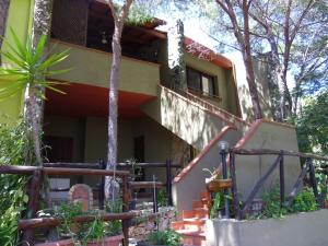 a house with a staircase leading up to it at Pinus Village Appartamento in Santa Margherita di Pula