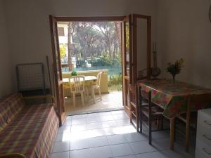 a living room with a door open to a patio at Rio Marina Bilo in Principina a Mare