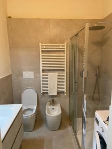 a bathroom with a toilet and a sink and a shower at Casa Bonacini in Reggio Emilia