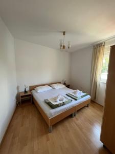 1 dormitorio con cama y ventana grande en Apartments Karma en Novalja