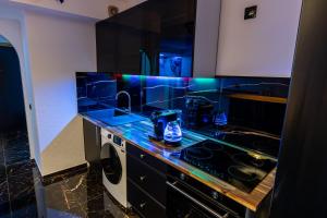 a kitchen with a counter with a sink and a stove at Home Angel spa in Strasbourg