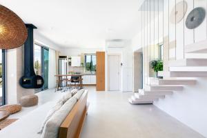 a living room with a couch and a staircase at Heniochos Villas in Chania Town