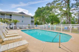 a swimming pool with chairs and a fence at Water-View Haven about 6 Mi to Myrtle Beach! in Little River