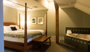 a hotel room with a bed and a bath tub at Lancaster Arts Hotel in Lancaster