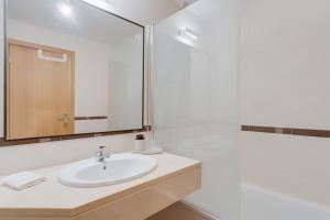 a bathroom with a sink and a mirror at Alta do Garajau I in Caniço +12 photos