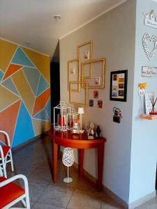 a table in a room with a colorful wall at Le Camerette di Edda in Cassino