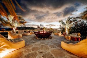 a person sitting in a fire pit on a patio at The Aerial, BVI All-Inclusive Private Island in Tortola Island