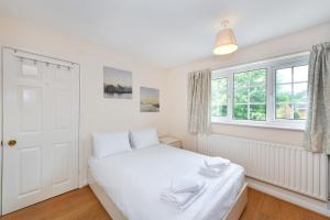 a bedroom with a white bed and a window at Lambourne House in Nottingham