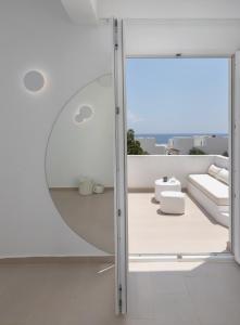 a glass door in a room with a view at VOCA HOTEL & SUITES in Kamari