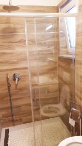 a shower with a glass door in a bathroom at House Marić in Poreč