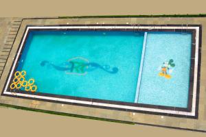 a swimming pool with an octopus in the water at Regenta Central Somnath, Bhalpara in Somnath