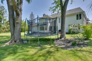 a house with a swing in the yard at Spacious Buffalo Brick Home w/ Backyard! in Buffalo