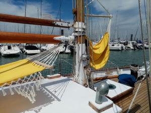 a boat with a yellow hammock on the deck at Superbe vieux greement a La Rochelle in La Rochelle