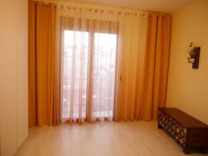 a room with a large window with orange curtains at Apartamento Guadiana Sol in Estepona