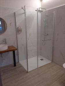 a shower stall in a bathroom with a sink at Casa Rural Triticum 