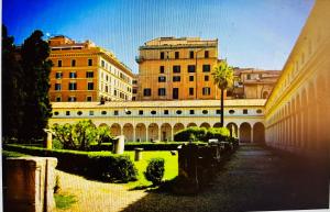 grupa budynków z drzewami i krzakami na dziedzińcu w obiekcie Siam Guest House Rome w Rzymie