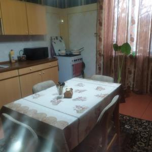 a kitchen with a table with a white table cloth at MariElla in Akhaltsikhe