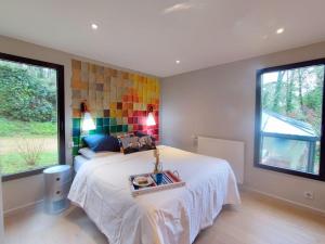 ein Schlafzimmer mit einem Bett und einer farbenfrohen Wand in der Unterkunft Superbe Villa d'architecte à 2 pas de la mer in Clohars-Carnoët