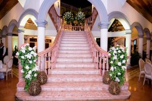 a staircase in a building with white flowers at Hotel Real La Merced in Granada