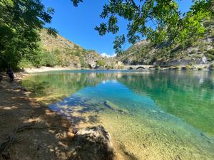 a body of water with a person walking on the shore at Appartamento Cuore D’Abruzzo in Scanno