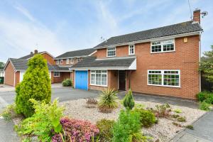 a red brick house with a blue door at Lambourne House in Nottingham