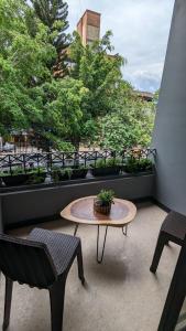 a patio with a table and two chairs and a table at UKU INN in Medellín