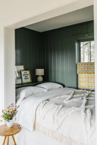 a bedroom with green walls and a large bed at The Wayback Boutique Hotel in Austin
