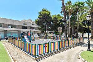a playground in a park with a colorful fence at Villa Luna in San Pedro del Pinatar