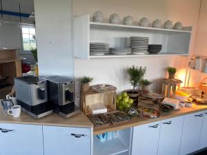 a kitchen with a counter with a microwave and food at Penzion ve věži in Bohumín