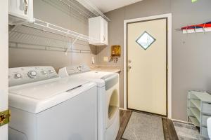 a laundry room with a washer and dryer at Secluded Hampstead Vacation Rental with Deck! in Surf City