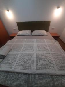 a large white bed with two pillows on it at Golden Stars in Arad