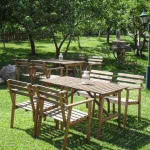 a wooden picnic table and chairs in a park at Apartamento O CASAL in O Grove