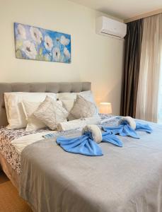 a bedroom with a bed with blue towels on it at Sea Garden Beach Studio in Saints Constantine and Helena +60 photos