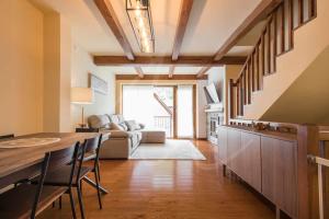 a living room with a table and a couch at Casa Artiga de Lin by SeaMount Rentals in Las Bordas