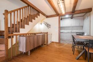 a kitchen and dining room with a staircase and a table at Casa Artiga de Lin by SeaMount Rentals in Las Bordas +31 photos