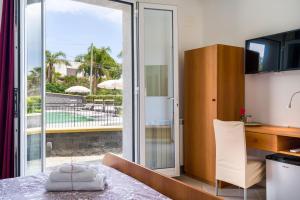 a kitchen with a dining table and a sliding glass door at Affittacamere villa Antonio in Aci Castello +200 photos