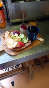 a cutting board with a plate of food on a counter at ArtMotel & Bistro in Haţeg