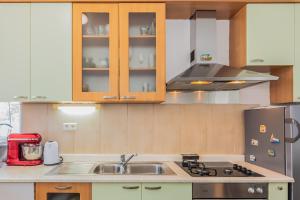a kitchen with a sink and a refrigerator at Blu Breeze Apartments in Lokva Rogoznica