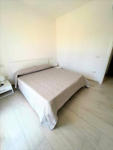 馬達萊納的住宿－Affittimoderni La Maddalena - MADA25，一间白色客房内的床铺卧室